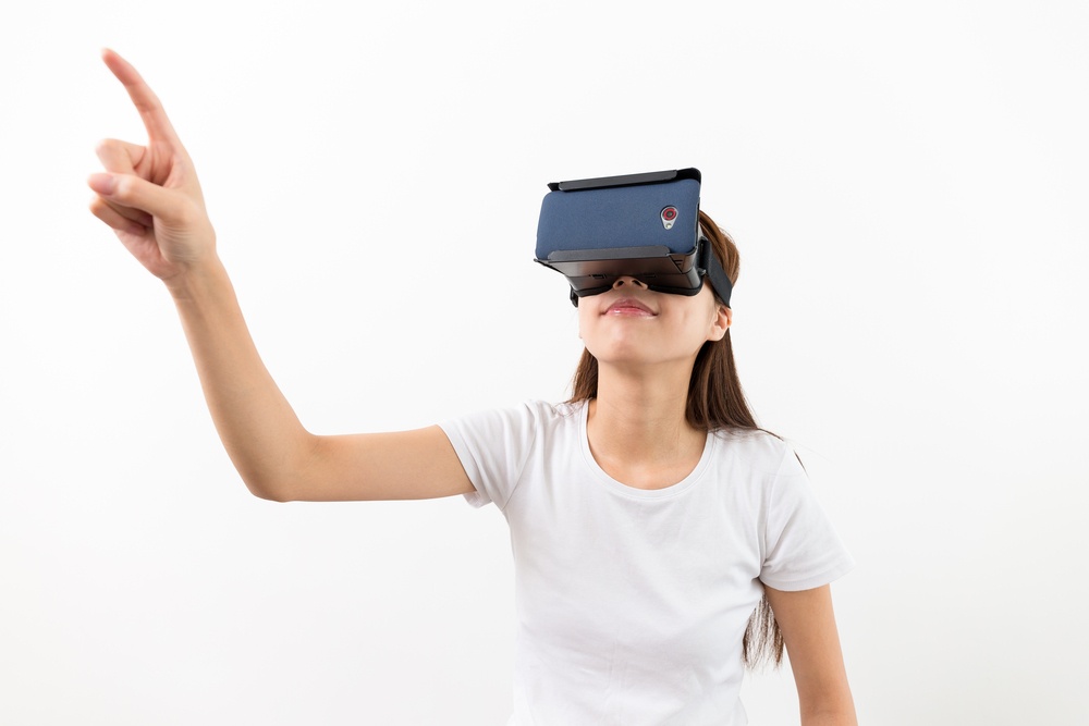 Woman wear with with VR device and finger touch in air.jpeg